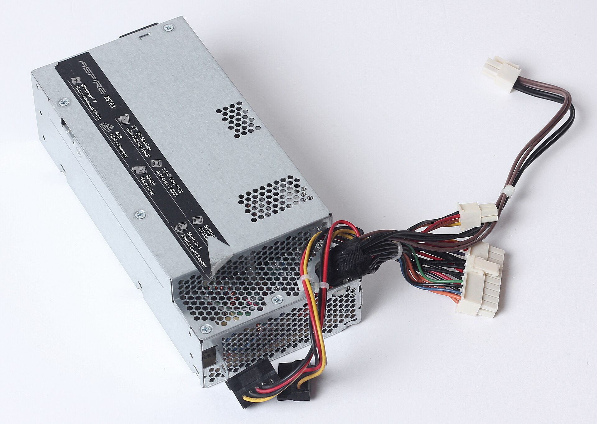 A small silver desktop power supply box with a bundle of coloured cables ending in white connectors