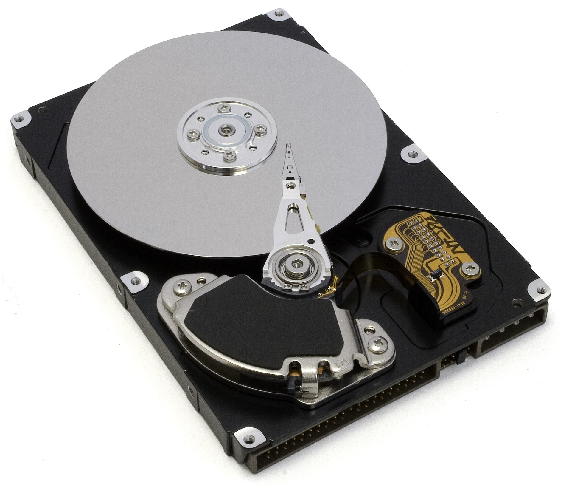 An opened hard drive showing the spinning platter and the moving arm