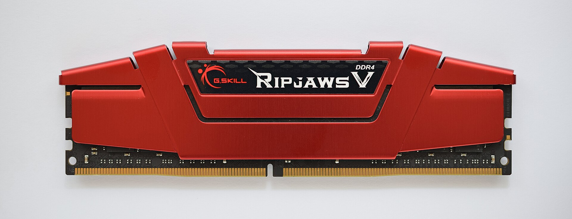 A red desktop RAM stick with a metal heat spreader, gold contacts and a notch along the bottom edge