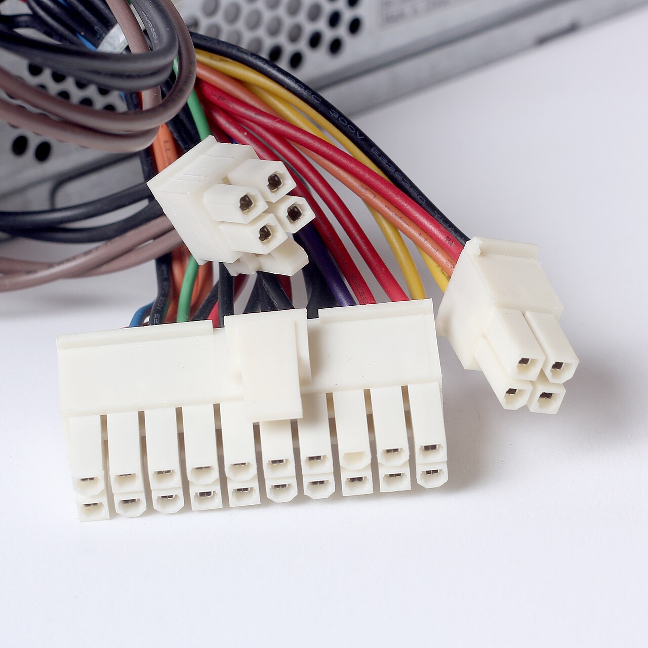 Cables from a PC power supply ending in a large 24-pin connector and several smaller plugs