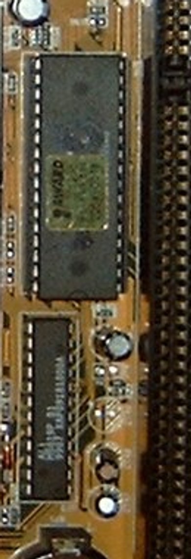 A close-up of an old rectangular BIOS chip with an AWARD sticker