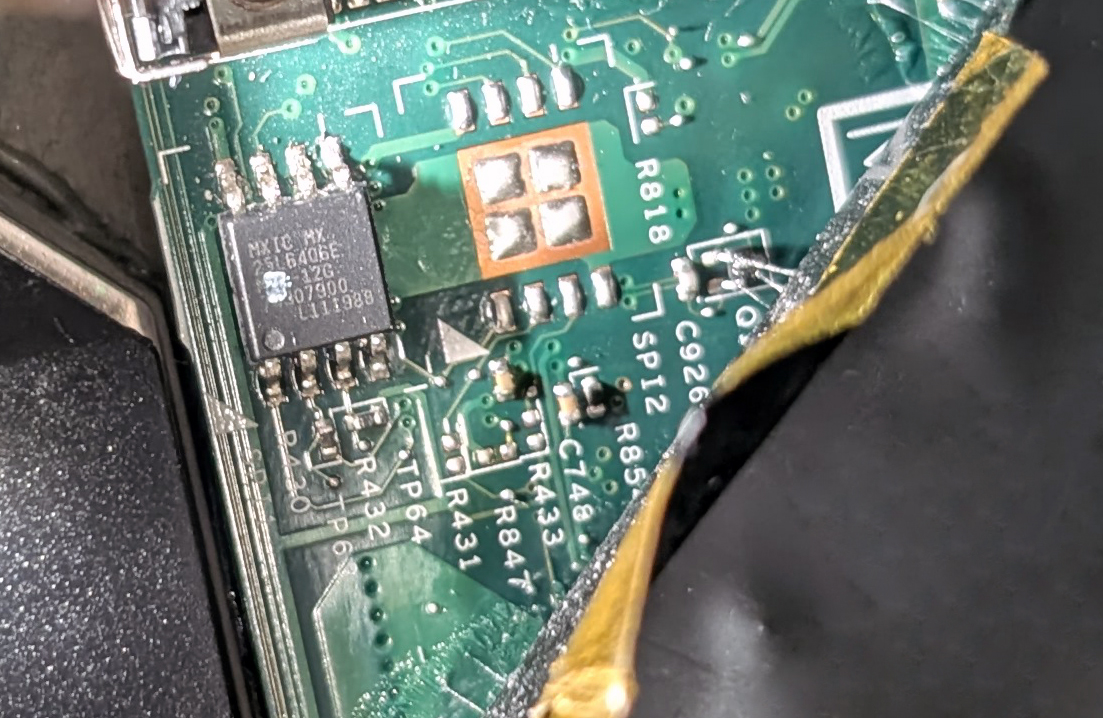 An 8-pin SPI flash chip on a laptop motherboard that holds the firmware