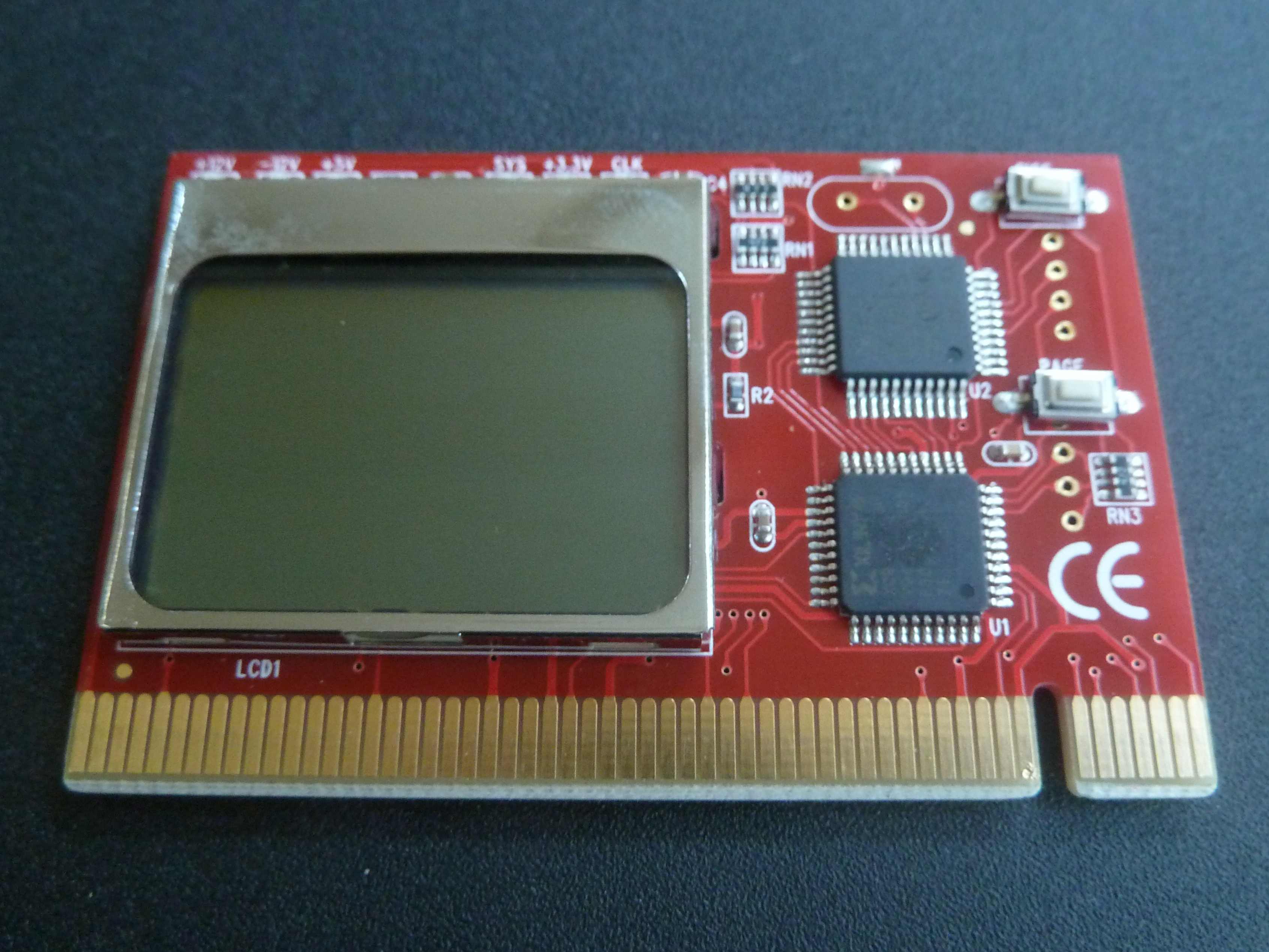 A red PCI add-in card with a small display, two chips and gold edge contacts